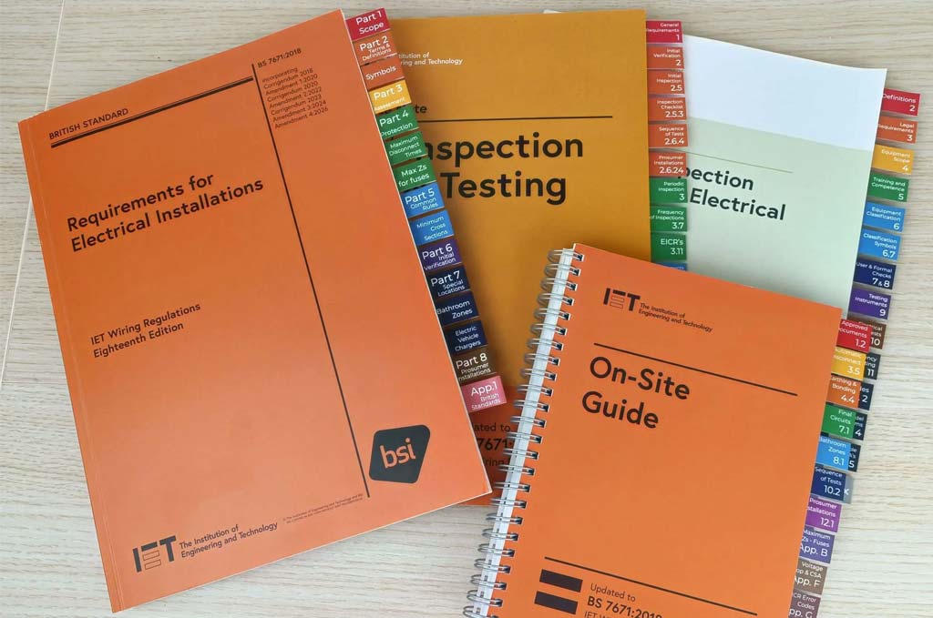 A selection of IET books with tab markers in use