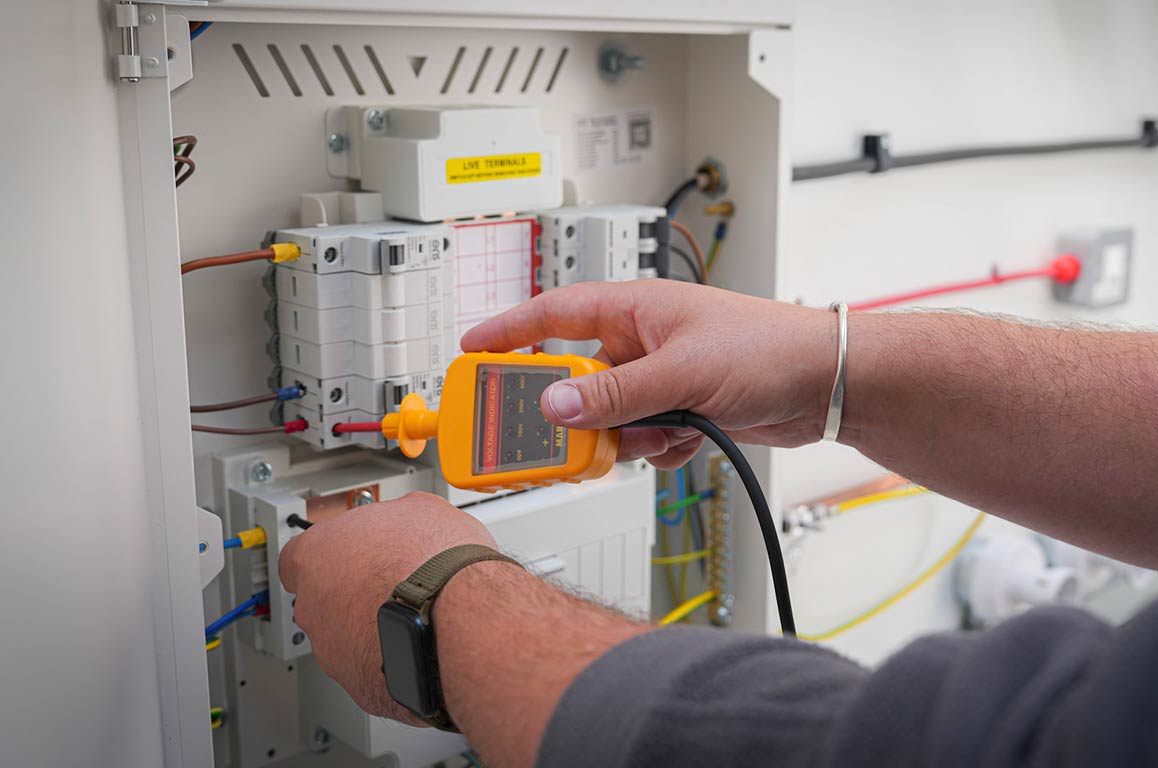 Delegate using a proving unit in an electrical training bay at PASS Stevenage